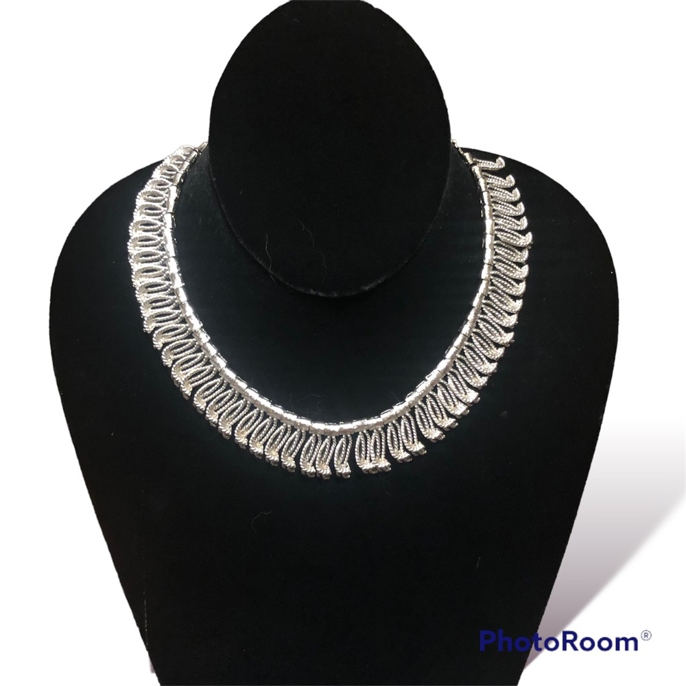 Vintage silver tone choker with articulated tassel-style embellishments.
